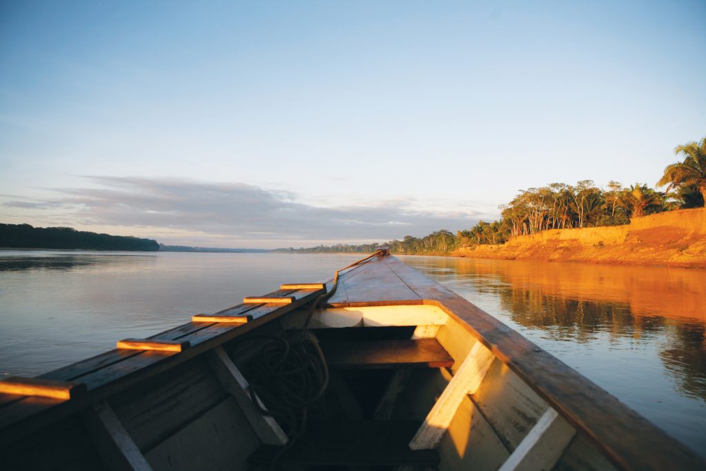 As day turns to evening you can watch the sun set over the Madre de Dios river.